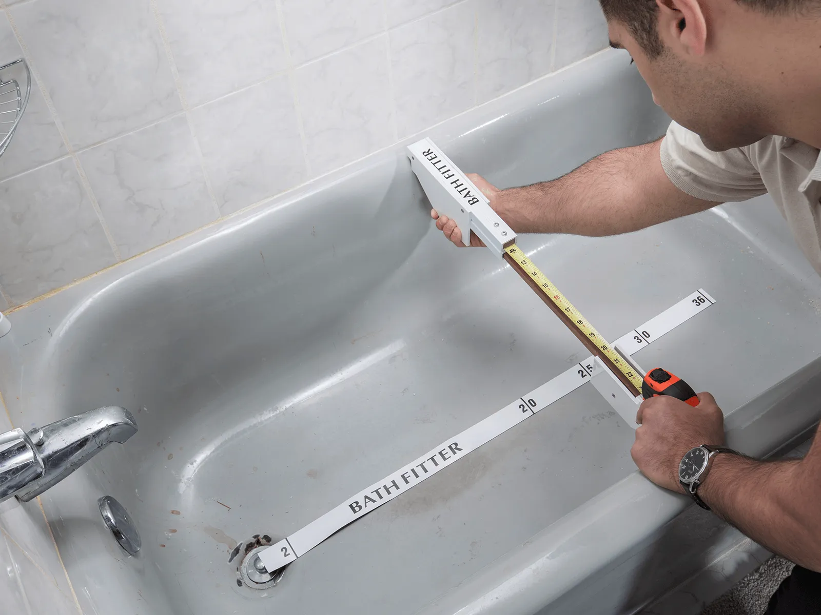 Old Home Bathroom Remodel Ideas - Bath Fitter employee measuring bathtub space