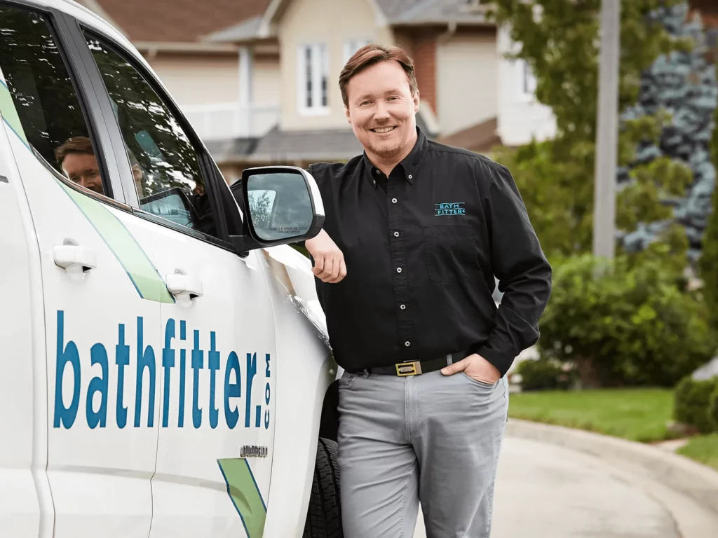 Bath Fitter Advantage - man leaning against Bath Fitter truck